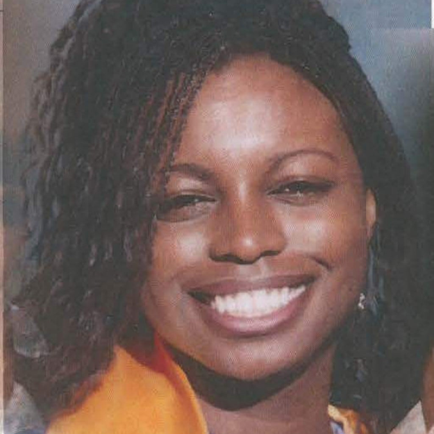 Graduation photo of Natasha McKenna, a young Black woman smiling joyfully.