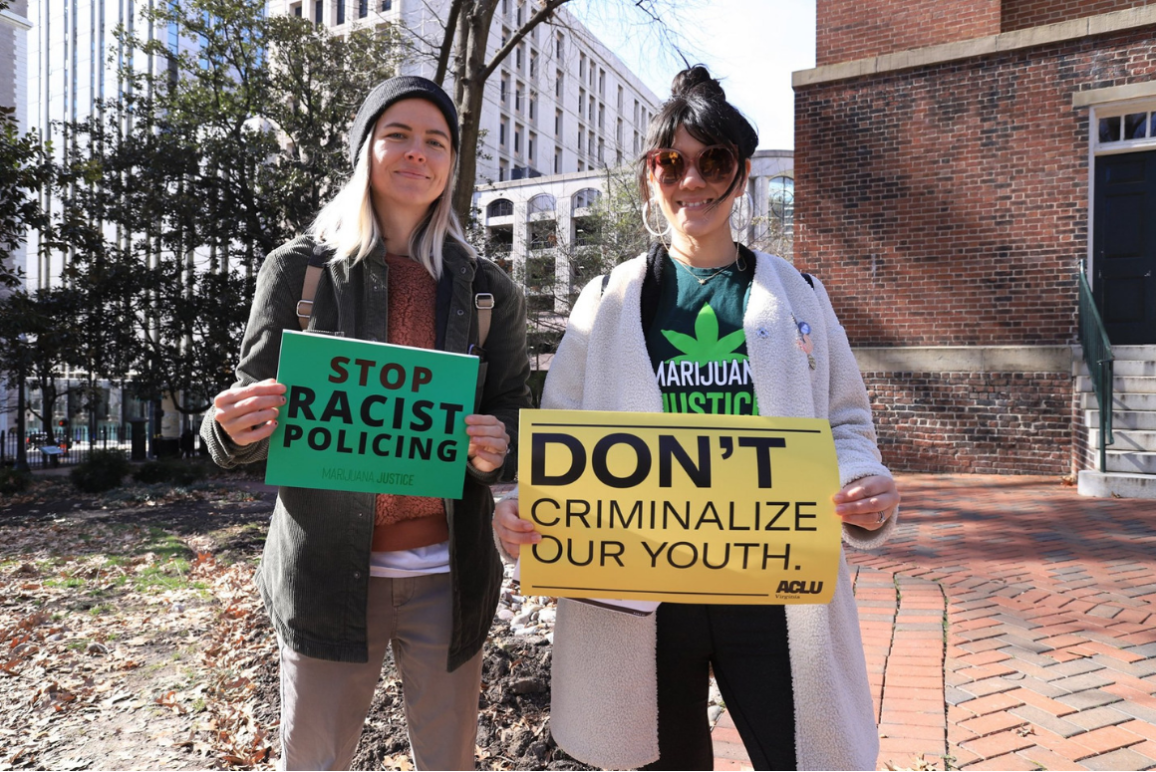Don't Criminalize Our Youth (website).png two protesters holding signs that say "Stop racist policing" and "Don't criminalize our youth"