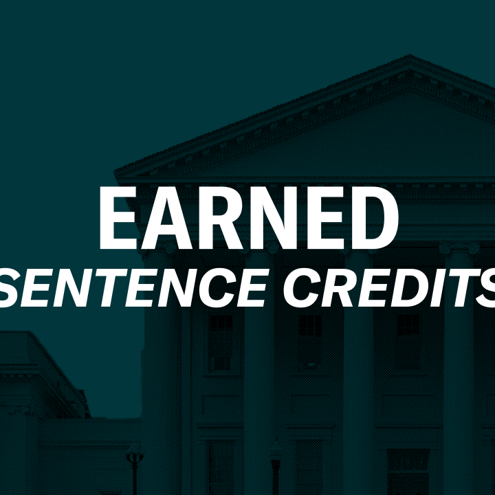 Over a a dark green background of the Virginia state capitol is a person embracing a recently returned Virginian in a hug. To the right of the graphics is a black gavel. In the middle of the graphic is text, "Earned sentence credits."