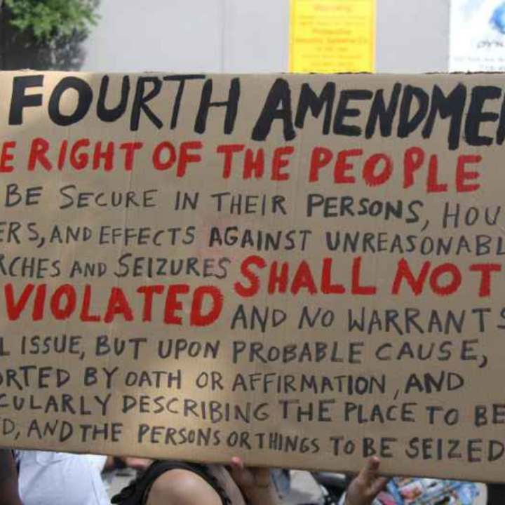 a protest sign with the fourth amendment written out on it