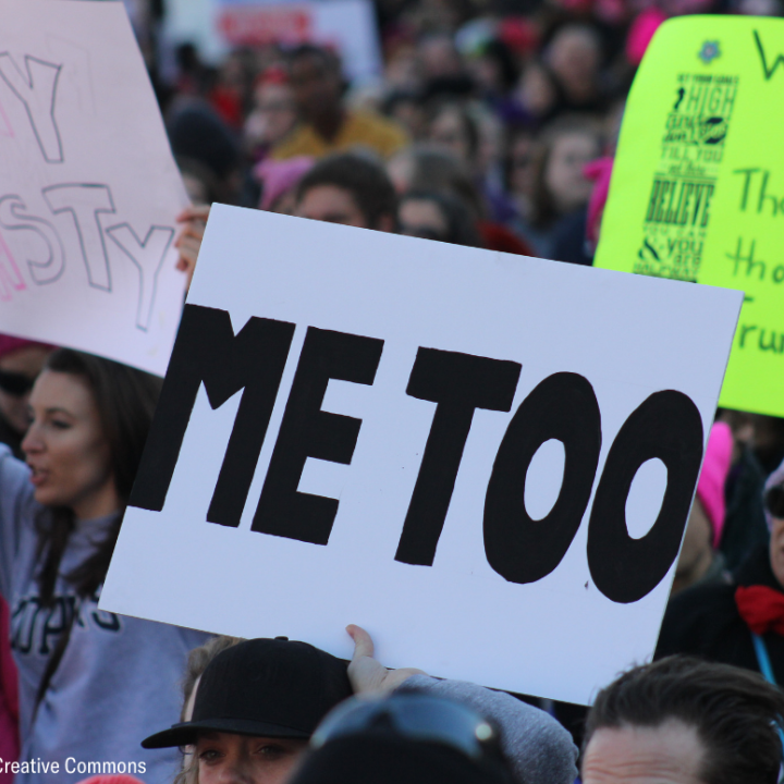 People carrying sign that says "Me Too"