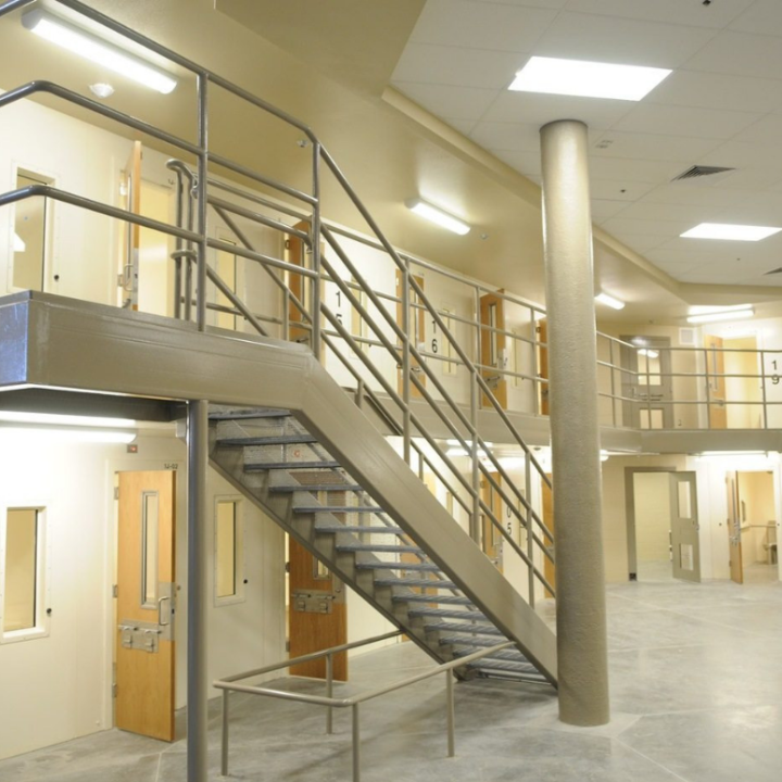 a wide-angle shot of a prison complex, with rows of prison cells